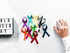 fita do dia mundial de conscientização do câncer com a mão de um médico Por PolonioVideo